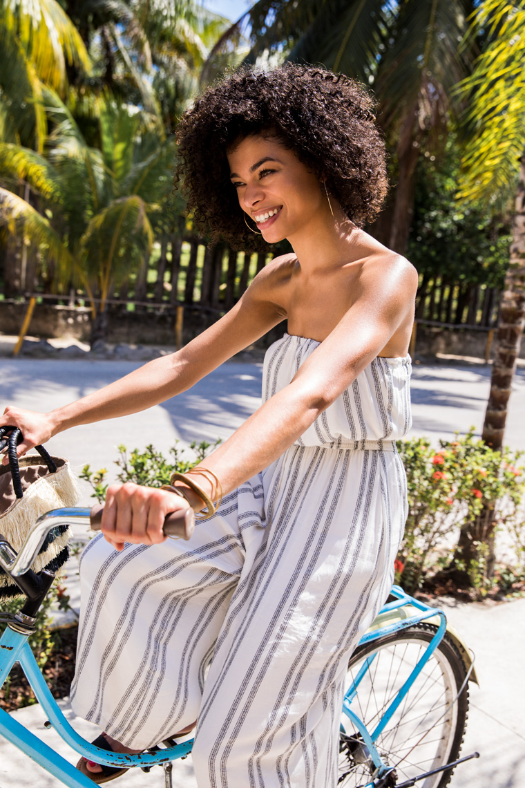 Woman riding bike and laughing