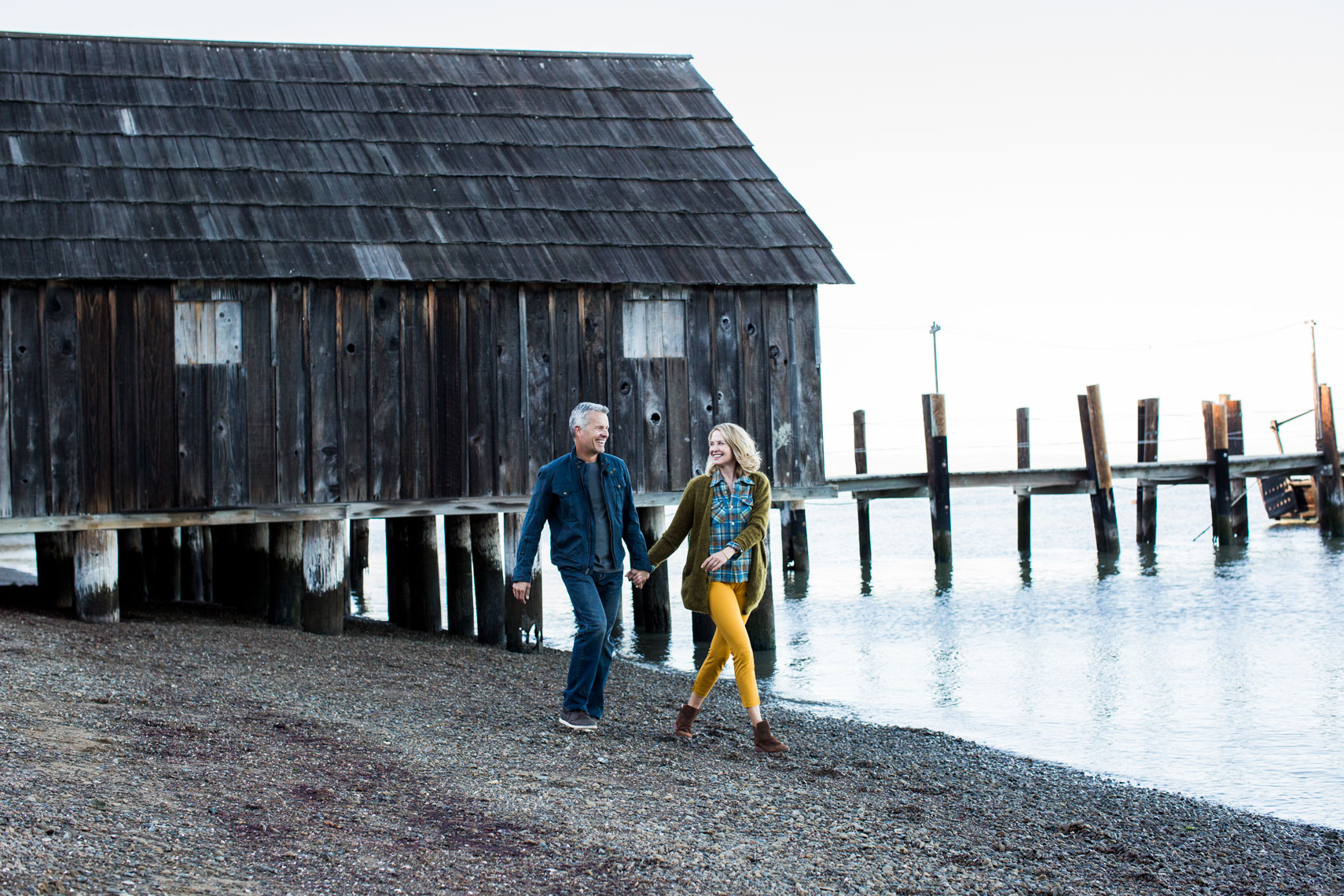 Older couple walking on the beach 