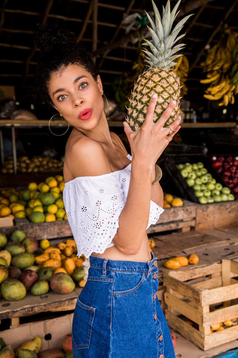 Girl holding a pineapple at the market